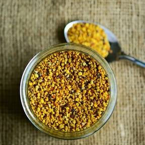 Jar of golden bee pollen on hessian